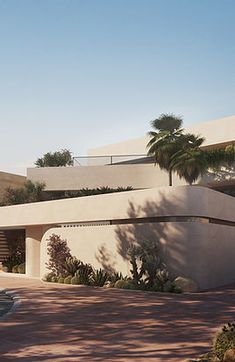 a modern house in the desert with palm trees