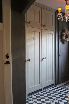 an entry way with two doors and a chandelier