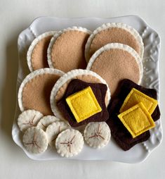 a white plate topped with cookies covered in felt