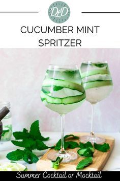 two glasses filled with cucumber mint spritzer on top of a cutting board