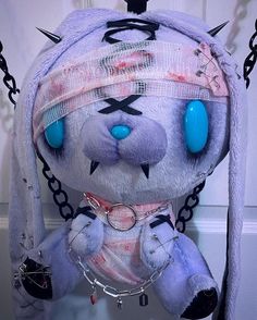 a stuffed animal with chains around it's neck