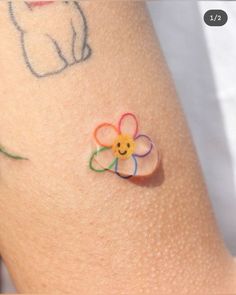 a small flower on the side of a woman's leg