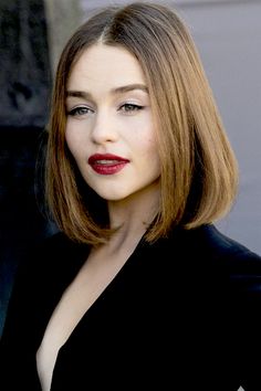 a woman with long hair and red lipstick