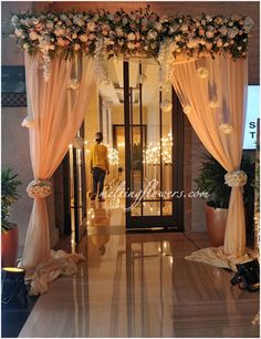 an entrance decorated with flowers and curtains