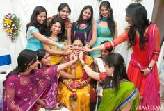 a group of women standing next to each other with their hands in the middle of them