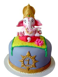 an elephant statue sitting on top of a cake