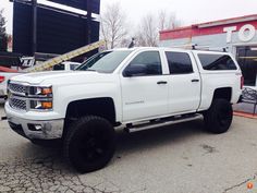 a white truck parked in front of a building