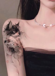 a woman with a cat tattoo on her arm