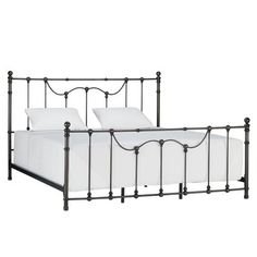 an iron bed frame with white sheets and pillows on the bottom, against a white background