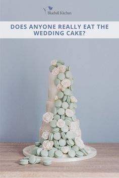 a wedding cake with flowers on it and the words does anyone really eat the wedding cake?