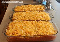 three pans filled with food sitting on top of a counter