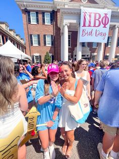 some people are standing in front of a building with a sign that says libo bid day