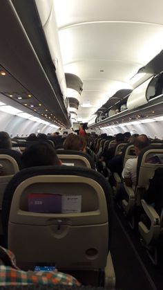 an airplane filled with lots of people sitting on seats