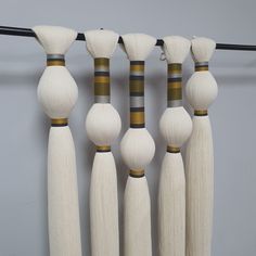 four white and black wooden poles hanging on a wall