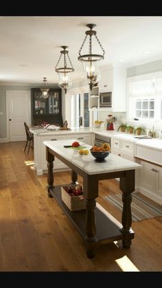 a kitchen with an island in the middle and lots of counter space on one side