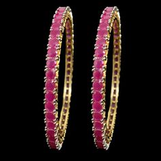 Add a pop of vibrant color to your look with our Pink Bangle from Agulka Jewels. The stunning Ruby Bangle complements the India-inspired design, creating a captivating piece of jewelry. The 22K Gold Plated finish adds a touch of luxury and elegance, while the Pakistani Bangle design brings cultural charm. Elevate your style with this exquisite and sophisticated bangle that exudes grace and allure. Let this be the perfect accessory to make a statement and add a touch of glamour to your ensemble. Gold Ruby Bangle, Red Hand Set Bangle For Party, Pink Bangle Jewelry For Diwali, Temple Jewelry Bangle Bracelets For Party, Pink Bollywood Bangle For Party, Pink Hand Set Bracelets For Festivals, Ruby Bangle For Wedding, Bollywood Style Pink Party Bracelets, Pink Bangle For Diwali Party