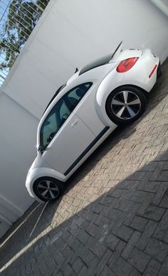 a small white car parked in front of a building