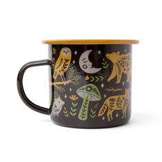 a black and yellow coffee mug with an owl, giraffe, and other animals on it