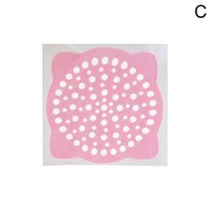 a pink doily with white dots on it and the word c in front of it