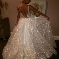 White Glamorous V-neck Sequin Dress, Glamorous White V-neck Evening Dress, White V-neck Wedding Dress With Sweep Train, Sequin A-line Evening Dress For Wedding, White V-neck Evening Dress For Prom Season, White V-neck Dress For Debutante Ball, Glamorous V-neck Wedding Gown, White Sequined Ball Gown For Wedding, White Sequined Wedding Ball Gown