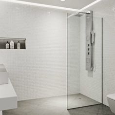 a white bathroom with a walk in shower next to a toilet