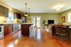 an open kitchen and dining room with hardwood floors