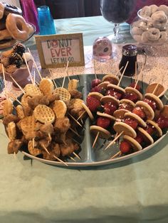 a platter filled with snacks and pretzels sitting on top of a table