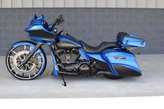 a blue motorcycle parked in front of a building