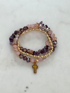 ✨ This gold cross charm stretch bracelet is made of the following: Size and Material: -Assorted faux purple beads bracelet with gold spacer beads, all strung on an elastic band. - In the center is a approximately 0.5-inch  gold cross charm - The bracelet is approximately 7 inches in length - Includes a 4mm gold beads  stretch bracelet ✨ Share and wear your faith with our small cross bracelet, a constant reminder of God's love. Order yours today and carry this reminder wherever you go!  💝 Ready to Gift: This bracelet arrives in a beautiful gift box, just like the one pictured! 🌸 Jewelry Care: - Roll bracelets on and off gently to maintain their shape. - Apply cosmetics, lotions, and perfumes before wearing your jewelry. - Remove jewelry before swimming, bathing, exercising, gardening, and Purple Beaded Bracelets, Purple Beads, Christian Jewelry, Cross Bracelet, Cross Charms, Gold Cross, Jewelry Cleaner, Beaded Stretch Bracelet, Beads Bracelet