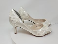 "Lace Wedding shoes.  Ivory bridal shoes that can also be dyed in over 100 additional colors, as well as matching a sample you provide.  .  They are embellished with delicate lace.  The shoe in this listing has a 3 inch heel, but is also available in heel size 2 inch. DYE COLORS: My goal is for you to have your shoes dyed the exact color you want.  Please understand that all computer monitors/phone screens are set to different settings which could make the color of the shoes you see in the listi Cream Round Toe Wedding Shoes For Bridal Shower, Fitted Almond Toe Court Shoes For Wedding, Fitted Almond Toe Wedding Court Shoes, Almond Toe Court Shoes For Wedding, Cream Lace Heels For Wedding, Cream Lace Wedding Heels, Cream Lace Wedding Shoes With Closed Toe, Fitted Almond Toe Wedding Shoes, Cream Lace Closed Toe Wedding Shoes