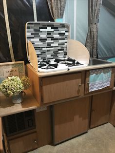 a stove top oven sitting inside of a kitchen