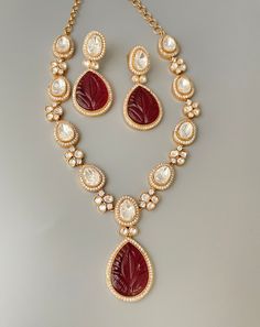 Premium quality moissanite polki necklace with long statement earring. This beautiful  long designer necklace is made with premium quality uncut polki kundan and red carved stone pendant  with American diamond details.   All orders Ship same day if placed before 4:00 PM EST  Earring Length: 2.25 inches Earring Width: 0.5 inches Necklace Length: 18 inches- adjustable with hook closure. Create beautiful memory for any occasion with elegant jewelry for your loved ones We will be happy to navigate you through the process so if you have any questions regarding our product before placing an order reach out to us and we will be there to help you.  Thank you for your visit and support Kundan Chandbali Necklace With Cut Dana, Festive Kundan Bridal Necklace With Cut Dana, Festive Kundan Necklace With Cut Dana As Gift, Festive Kundan Necklace With Cut Dana For Gift, Festive Kundan Chandbali Necklace With Cut Dana, Bollywood Style Chandbali Kundan Necklace With Cut Dana, Elegant Kundan Necklace With Cut Dana For Festive Occasions, Bollywood Style Festive Necklace With Cut Dana, Kundan Long Necklace