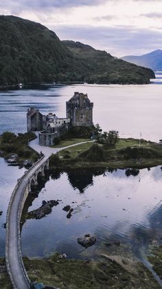 an aerial view of a castle in the middle of water