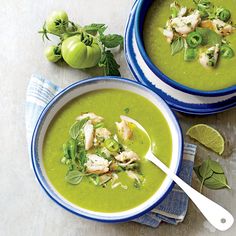 two bowls of green soup on top of a newspaper with an article about the recipe