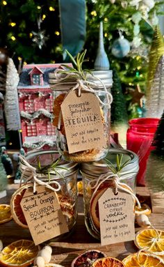 jars filled with different types of dried fruit and spices on top of a wooden table