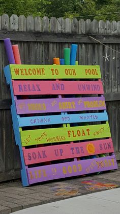 a colorful sign that says welcome to our pool