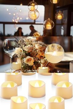 many candles are lit in front of a table with flowers and wine glasses on it