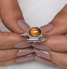 Tiger Eye Ring, 925 Sterling Silver Ring, Oval Gemstone Ring, Adjustable Ring, Women Silver Ring, Handmade Jewelry, Best Friend Gift Ring Gemstone Name - Tiger's Eye  Stone Quality - AAA  Weight - 3.18 gm  Stone Shape - As shown in the picture Ring Size - All Ring Size Available  We serve complete 925 sterling silver Jewelry and genuine properties of the stone.  The products are dispatched from the small business from UK. Product Quality and Packaging - Our all products are 925 Silver Stamped which shows that the product is genuine and authentic .The products are dispatched from the small business from UK so you get the product on time and the product packaging comes in bubble foil wrap with all the precautions taken primarily that your product reaches you with zero damage. Properties of T Oval Sterling Silver Stackable Rings Fine Jewelry, Oval Sterling Silver Stackable Rings, Adjustable Oval Gemstone Stackable Rings, Adjustable Oval Rings With Ethical Gemstones, Oval Sterling Silver Stackable Rings With Polished Finish, Stackable Oval Sterling Silver Crystal Ring, Unique Adjustable Oval Stackable Rings, Adjustable Oval Stackable Rings With Polished Finish, Adjustable Oval Stackable Rings