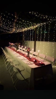 a long table is set up with candles and place settings for the dinner guests to enjoy