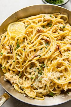 a pan filled with pasta and sauce on top of a table