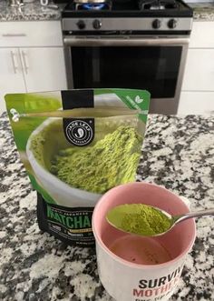 a bag of matcha next to a bowl of matcha powder on a kitchen counter