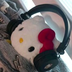 a hello kitty stuffed animal with headphones on