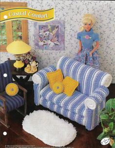 a doll is sitting on a blue and white striped chair in a living room with yellow pillows