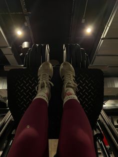 the legs and feet of a person in red pants