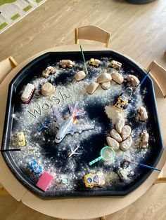 a child's play table with rocks and magnets on it that spell out the word wow