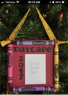 a school photo frame ornament hanging on a christmas tree