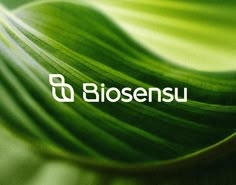 a green leaf with the word biosenu on it's bottom corner in white