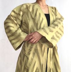 "Luxurious, handmade and unique double sided duster coat for any occasion! This nuno felt & double silk duster coat from Kyrgyzstan is made by Farzana Sharshembieva - a master artisan who has won many international awards of UNESCO Award Of EXCELLENCE.  This luxuriously fine item is made using 100% natural merino wool with 100% natural silk with double layer and is made with wet--felting technique called \"nuno felting\". This handmade coat is light, extremely warm, soft and double sided! From a technical standpoint, the work is difficult, with the creation of a single garment requiring many individual steps. The laborious process yields beautifully unique items. These geometrical patterns are inspired by traditional kyrgyz patters from \"TERME\" woven ribbons for yurt ties and are cut by Silk Duster Coat, Silk Duster, Award Of Excellence, Felt Coat, Felt Handmade, Nuno Felt, Silk Coat, Nuno Felt Scarf, Maxi Coat