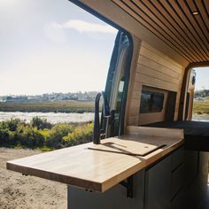 the interior of a camper van with an oven and counter top in front of it