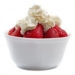 strawberries with whipped cream in a white bowl